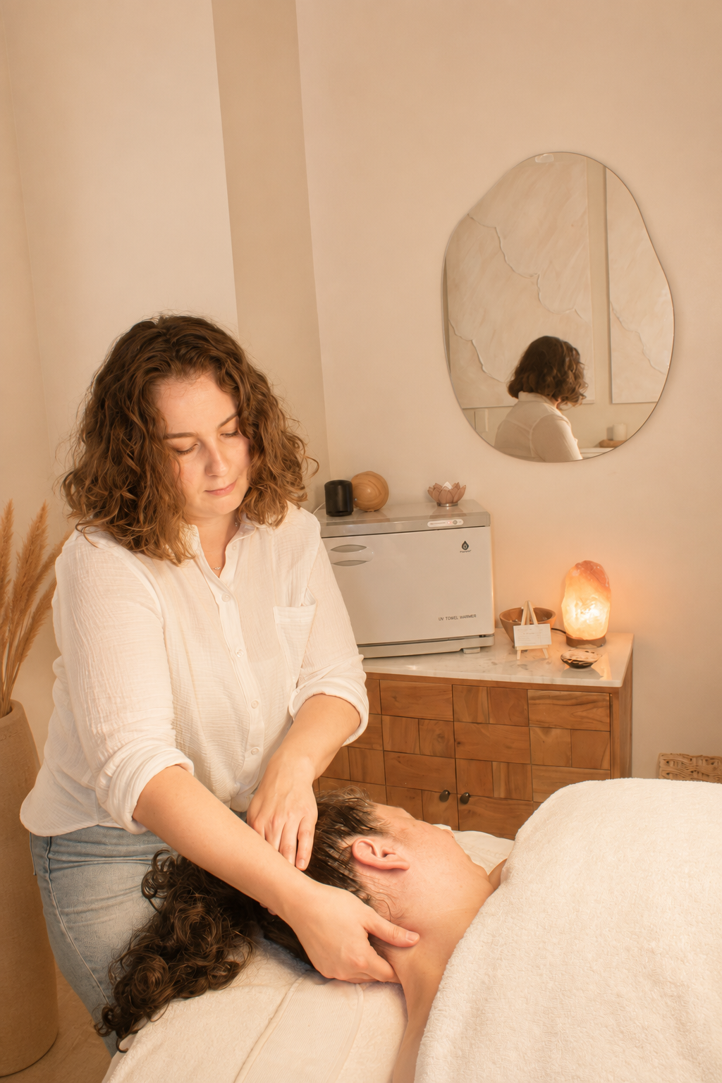 Anna Leigh performing a scalp and neck massage during a facial